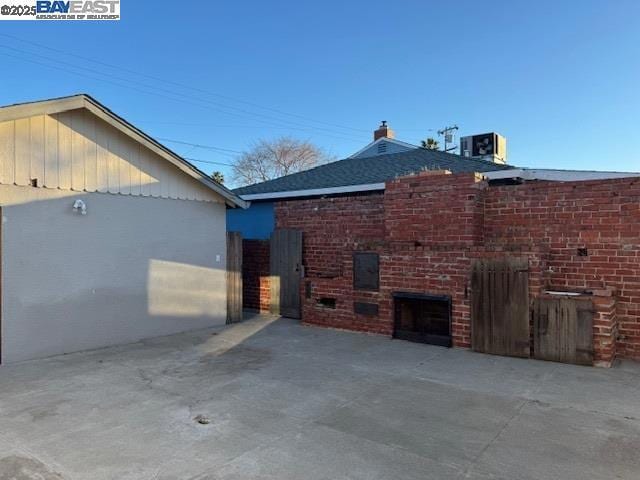 view of home's exterior with central air condition unit and a patio area