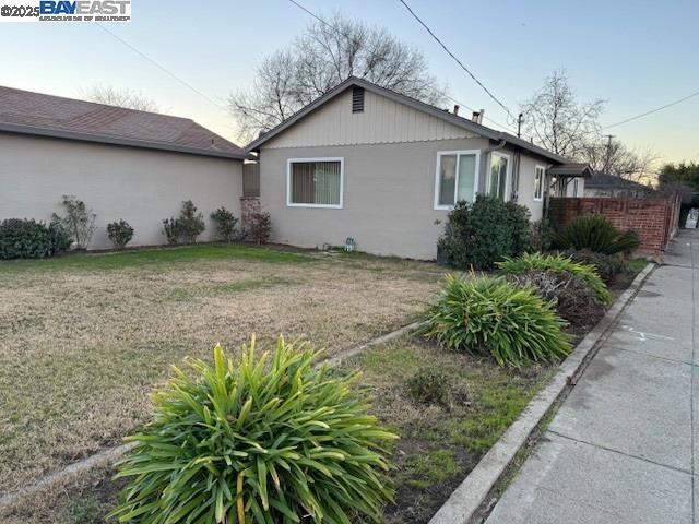 view of side of home featuring a yard