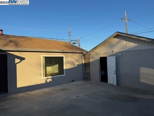 view of side of home featuring a patio area