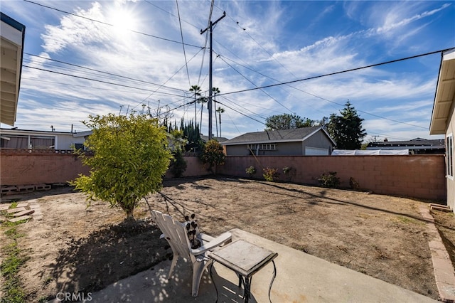 view of yard with a fenced backyard and a patio