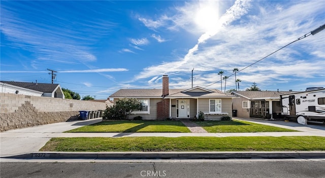 ranch-style house with a chimney, fence, and a front yard