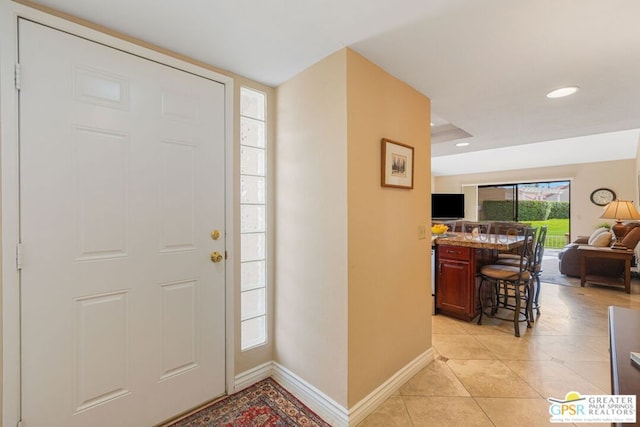 entryway with light tile patterned flooring