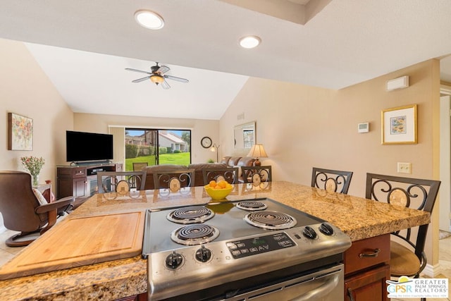 kitchen featuring vaulted ceiling, stainless steel electric range oven, ceiling fan, and light stone countertops