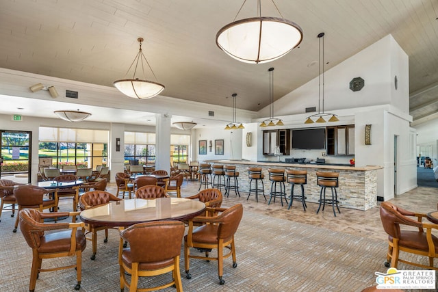 dining space featuring wood ceiling and high vaulted ceiling