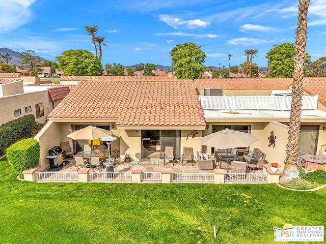 back of property featuring a yard and a patio