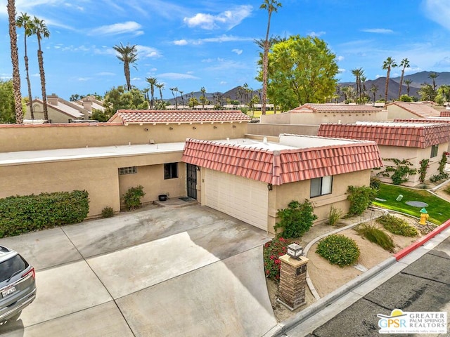 view of front of property featuring a mountain view and a garage