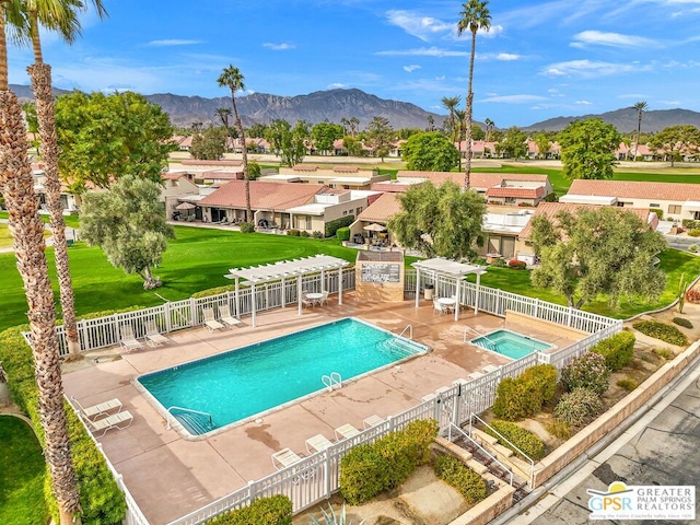 view of swimming pool with a patio area, a pergola, and a mountain view