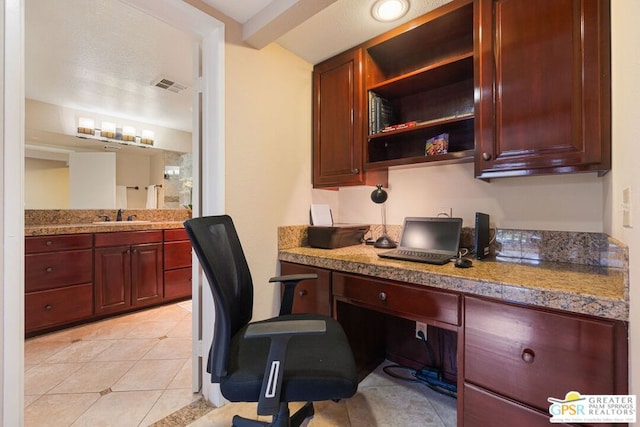 tiled office space with built in desk and sink