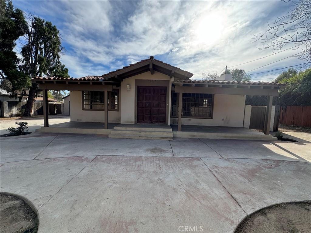 view of front of house with a garage and a carport