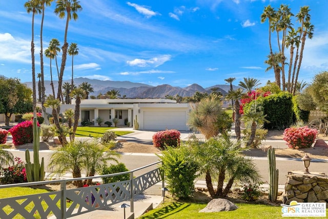 view of front of home featuring a garage and a mountain view