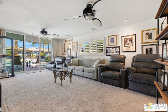 carpeted living room featuring floor to ceiling windows and ceiling fan