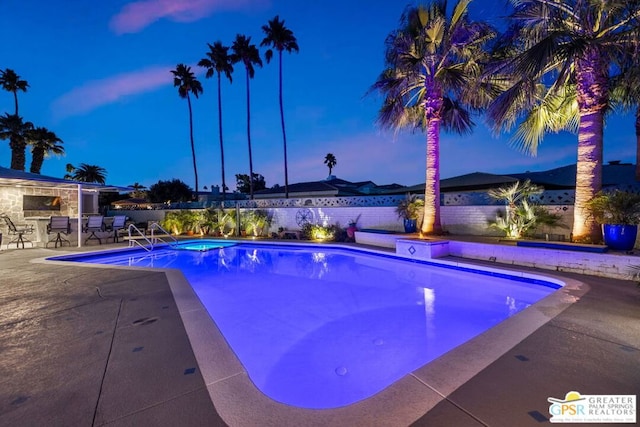 view of pool at dusk