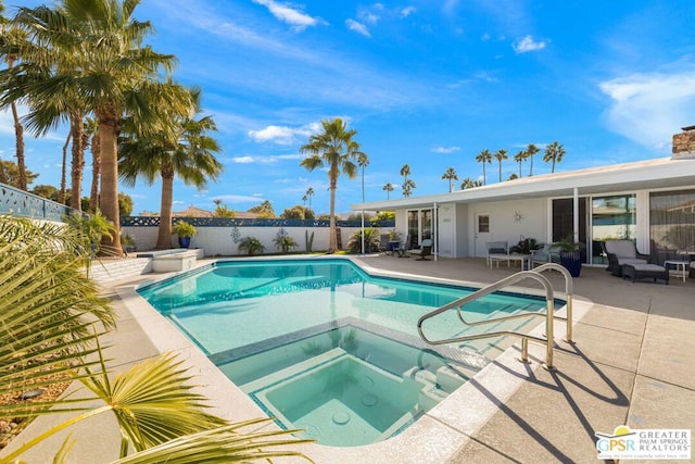 view of swimming pool with an in ground hot tub and a patio area