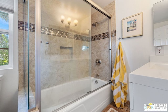 bathroom with vanity and bath / shower combo with glass door