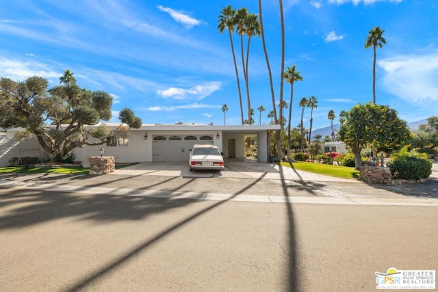 view of front of house with a garage and a carport