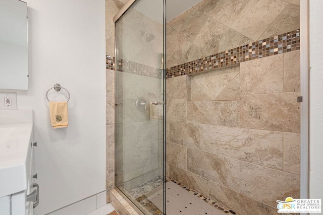 bathroom with vanity and a shower with door