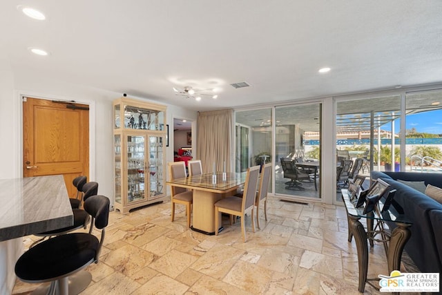 dining area with floor to ceiling windows