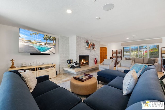 living room with a fireplace and a textured ceiling