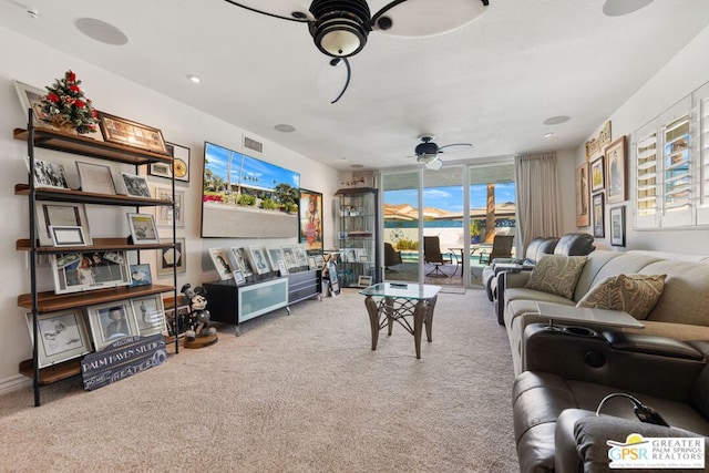 living room featuring carpet flooring and ceiling fan