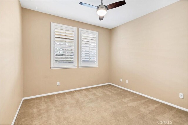 carpeted empty room featuring ceiling fan