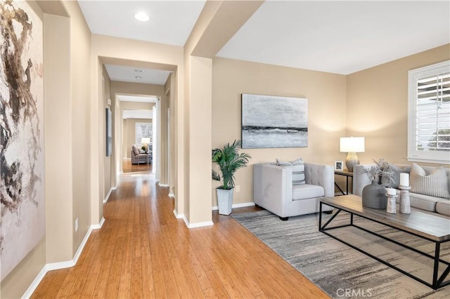 living room with a wealth of natural light and light hardwood / wood-style floors