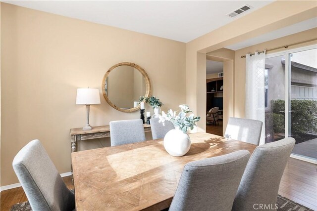 dining area featuring dark hardwood / wood-style floors