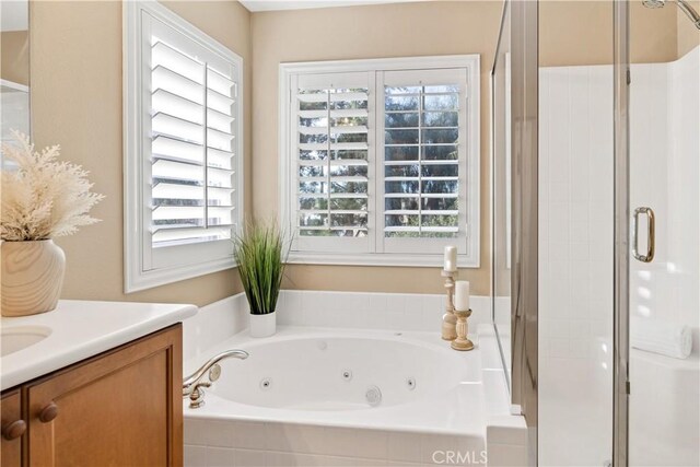 bathroom with a wealth of natural light, vanity, and plus walk in shower