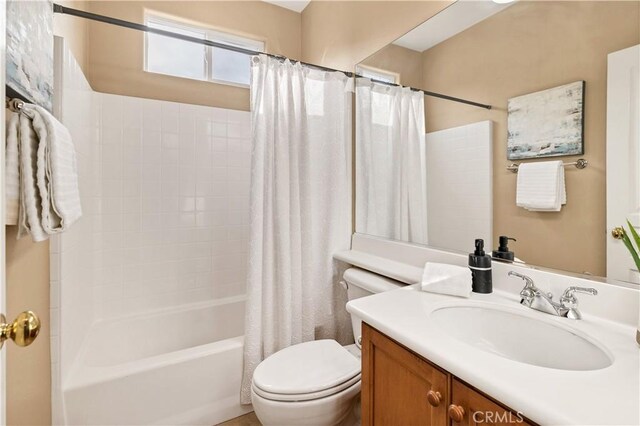 full bathroom featuring toilet, vanity, and shower / tub combo with curtain