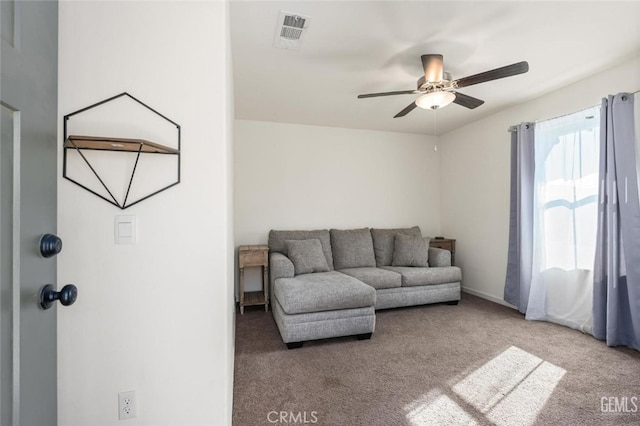 carpeted living room with ceiling fan