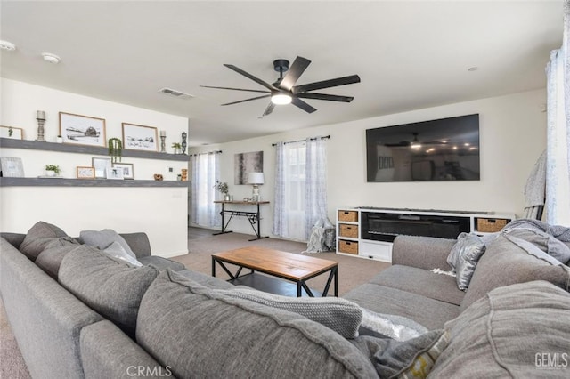 carpeted living room featuring ceiling fan