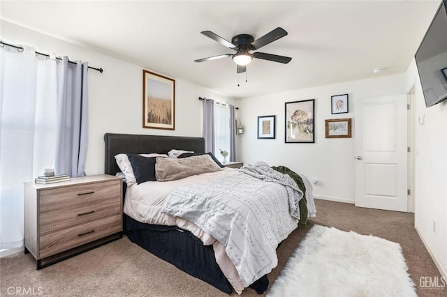 bedroom with dark colored carpet and ceiling fan