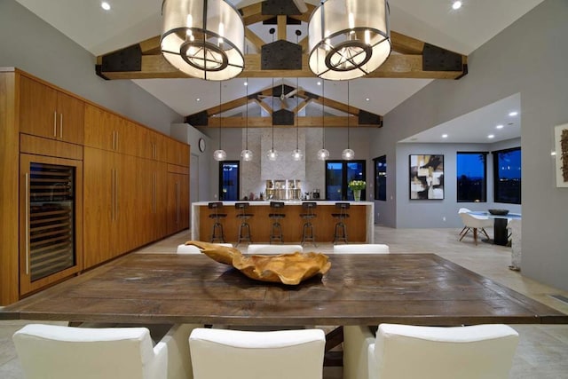 dining room with high vaulted ceiling, beam ceiling, wine cooler, and a chandelier