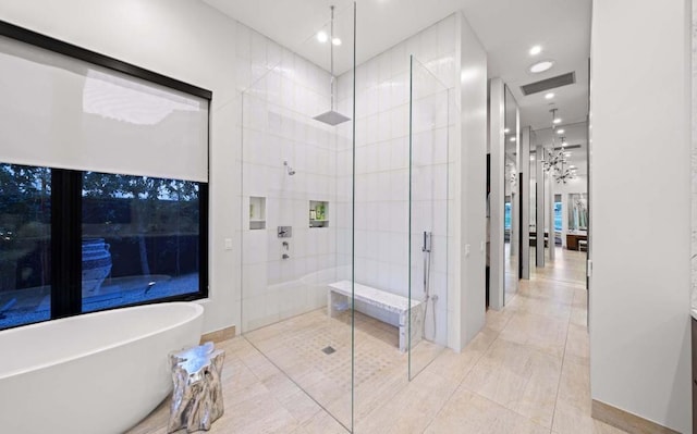 bathroom with separate shower and tub and tile patterned floors