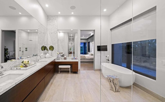 bathroom with vanity and independent shower and bath