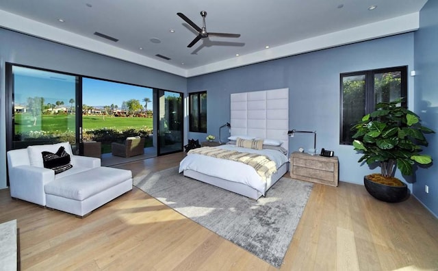 bedroom featuring light wood-type flooring, ceiling fan, and access to exterior