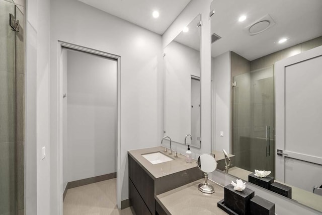 bathroom with a shower with door and vanity