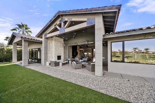 back of property with ceiling fan, a yard, a patio, and outdoor lounge area