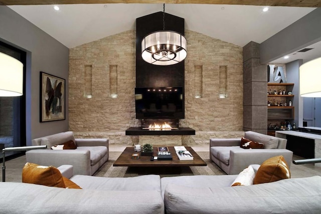 living room featuring vaulted ceiling, a chandelier, indoor bar, a fireplace, and built in features