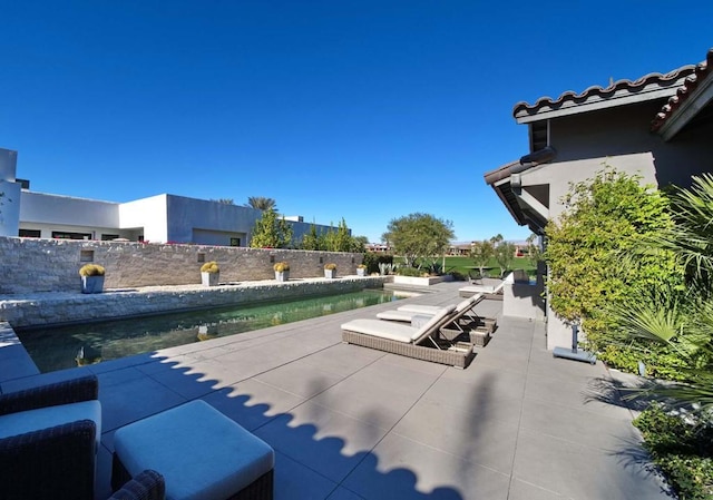 view of patio / terrace with a fenced in pool