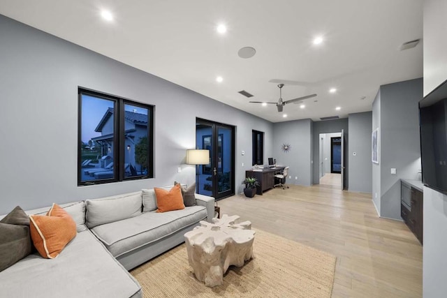 living room featuring ceiling fan and light hardwood / wood-style flooring