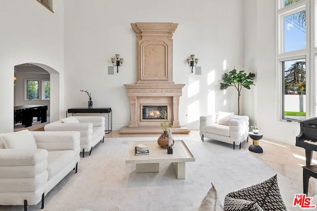 living room featuring a high ceiling and a premium fireplace