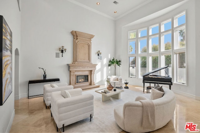 sitting room with ornamental molding and a towering ceiling