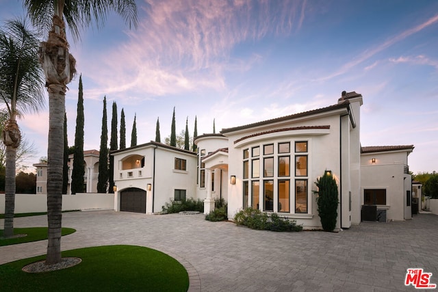 mediterranean / spanish-style home featuring a garage