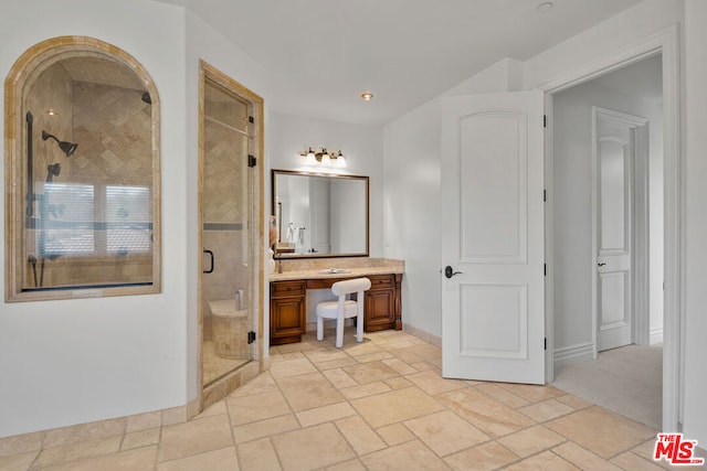 bathroom with an enclosed shower and vanity