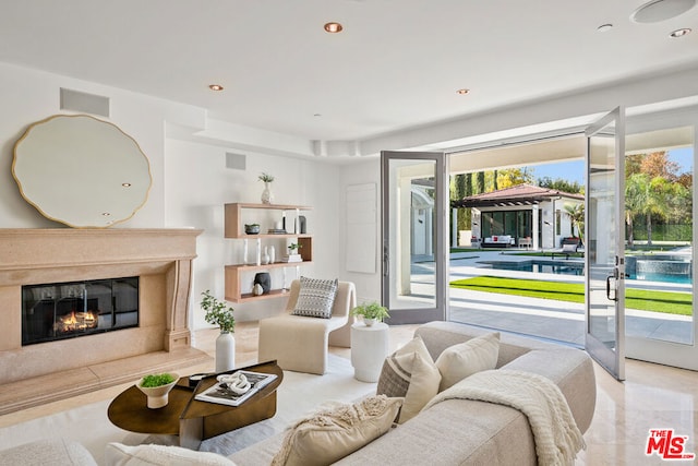 living room featuring a premium fireplace and plenty of natural light