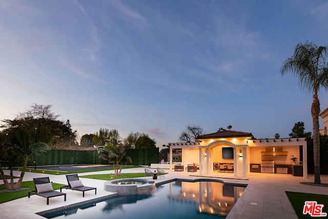 view of swimming pool with a pergola, a patio, an in ground hot tub, and exterior kitchen