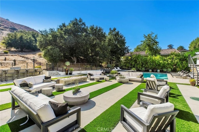 view of patio featuring a fenced in pool, a mountain view, and outdoor lounge area