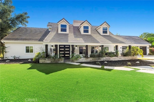 rear view of house featuring a yard