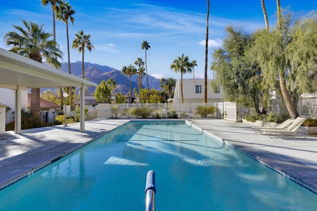 view of pool with a patio area and a mountain view