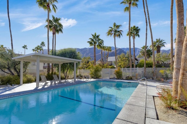 view of pool with a patio and a mountain view